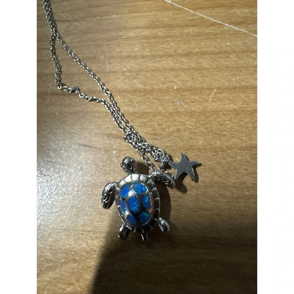 silver turtle necklace with simulated blue opal
